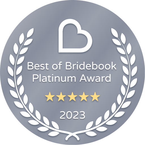 A badge that says `` best of bridebook platinum award '' with a heart and laurel wreath.