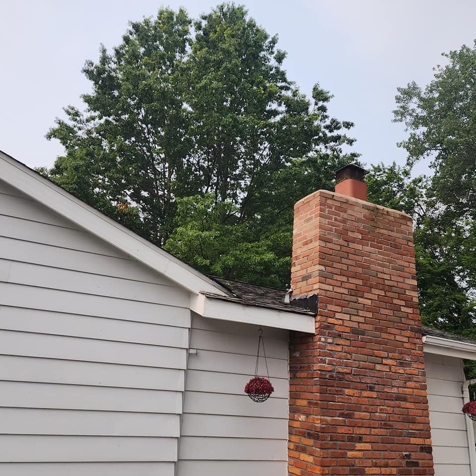 A brick chimney on the side of a house