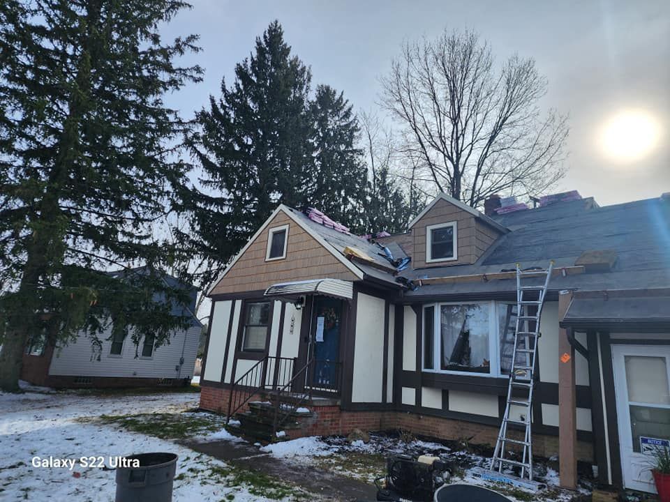A house with a ladder in front of it is being remodeled.