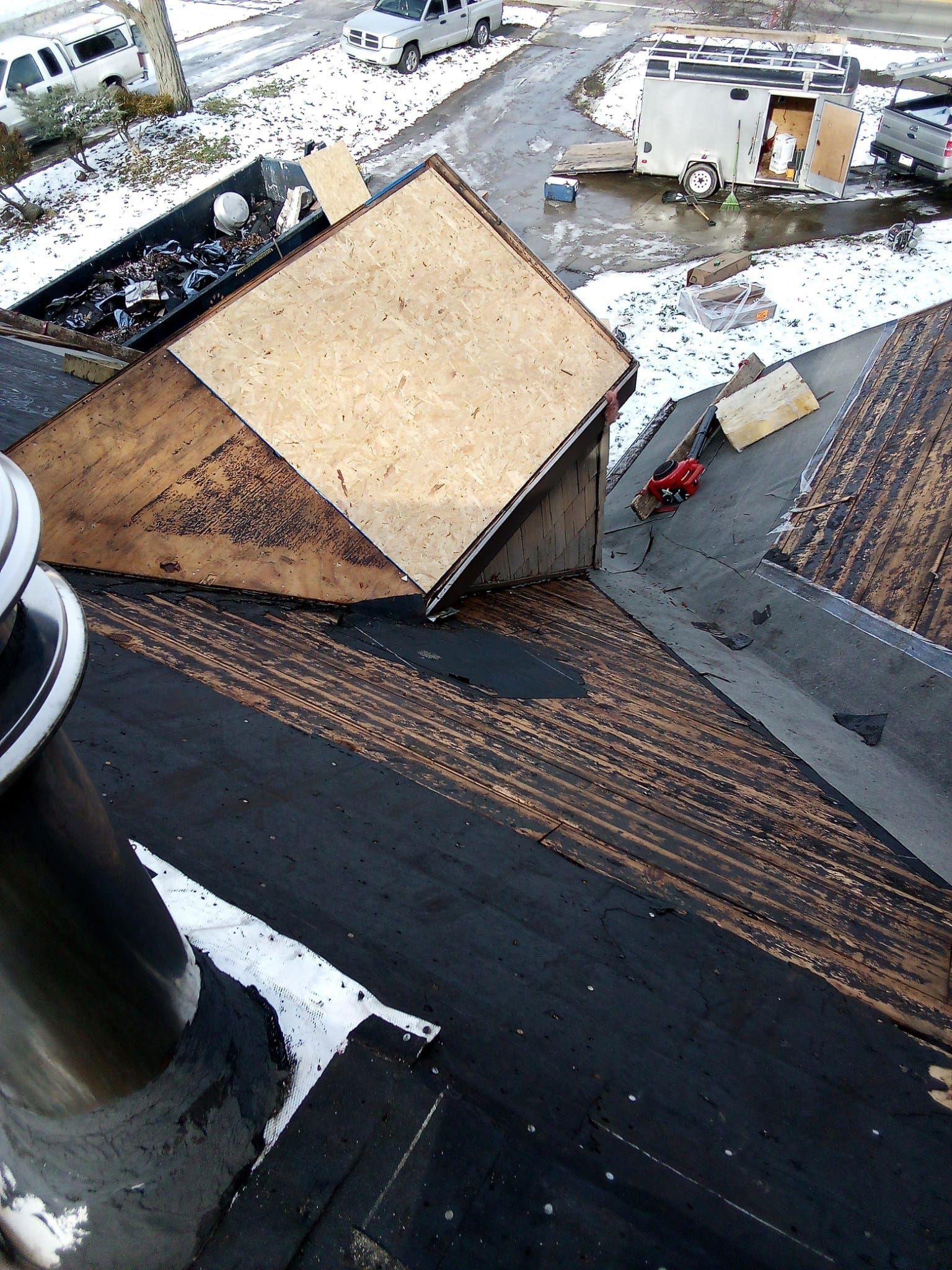 An aerial view of a roof with a piece of plywood on it