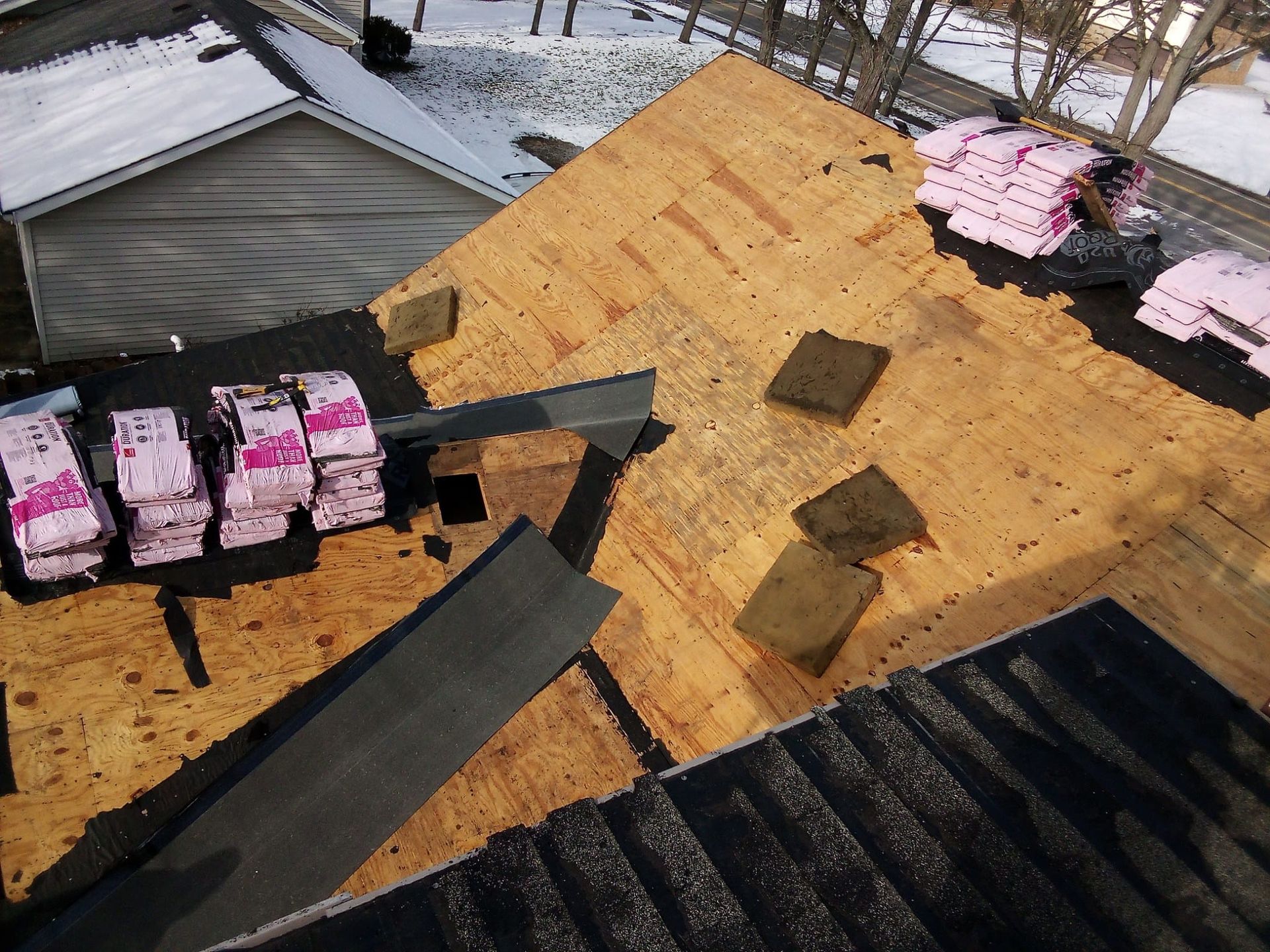 A roof with a lot of pieces of plywood on it