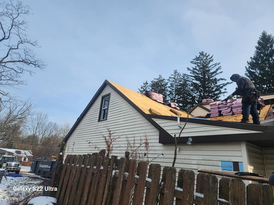 A man is working on the roof of a house.