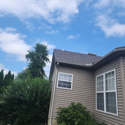 A house with a lot of windows and a blue sky in the background.