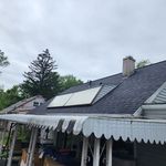 A house with a roof that has solar panels on it