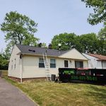 A house with a dumpster that says rent me on it