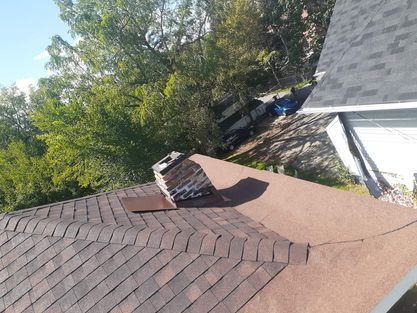 A chimney is sitting on the roof of a house.