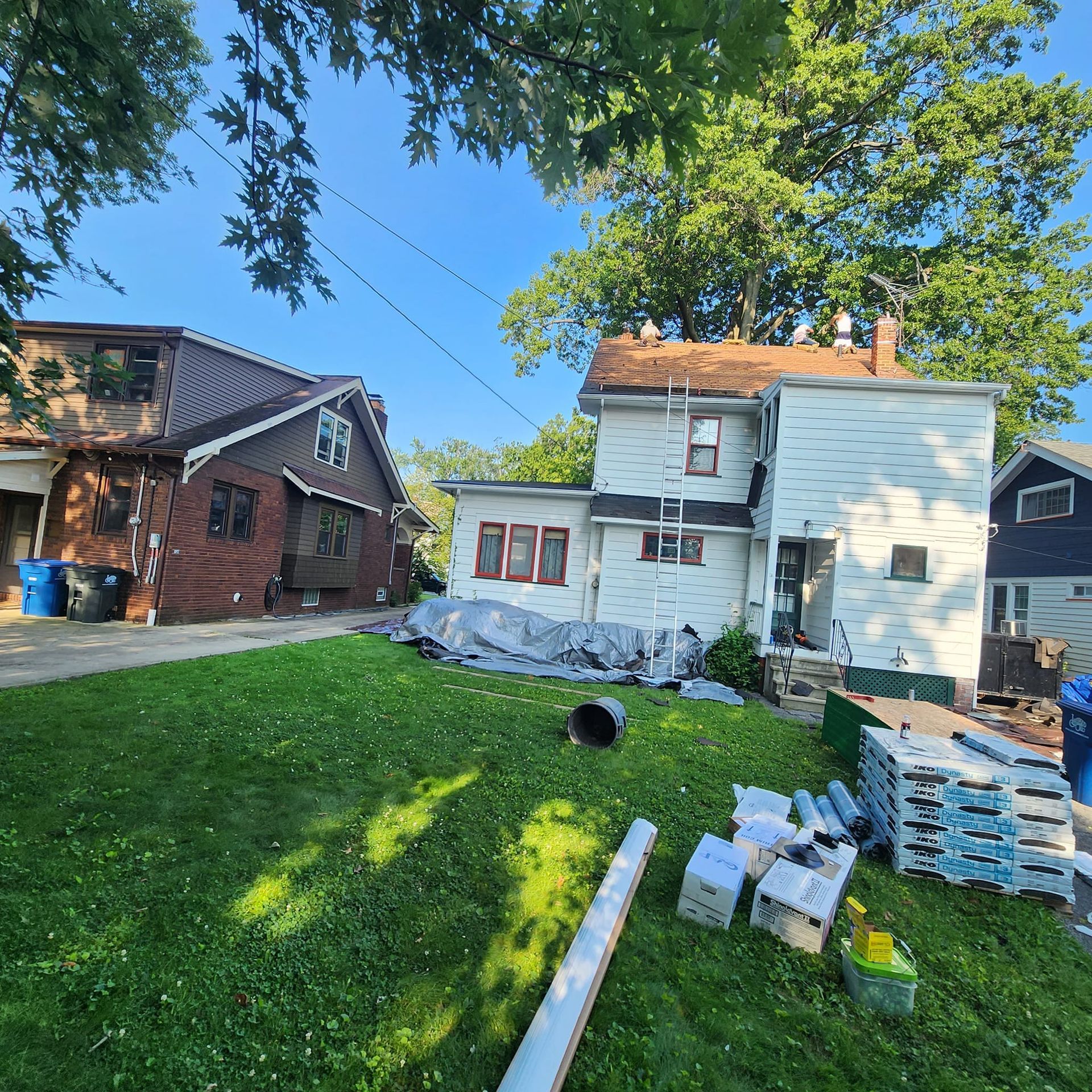 Two houses are sitting next to each other on a lush green lawn.