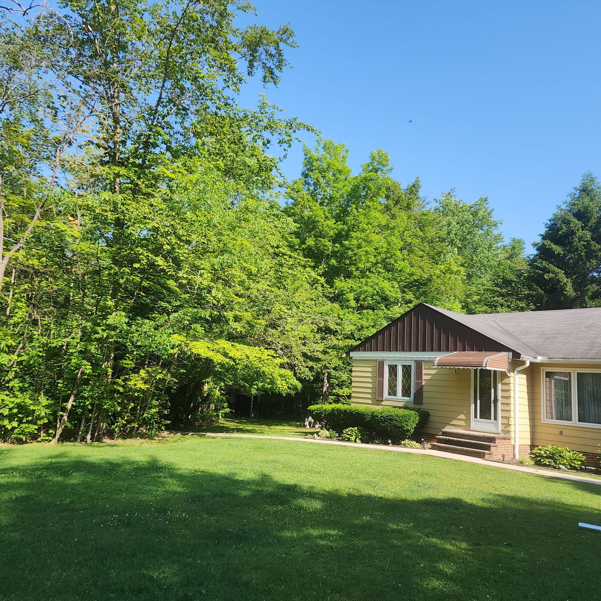 A house with a large lawn in front of it