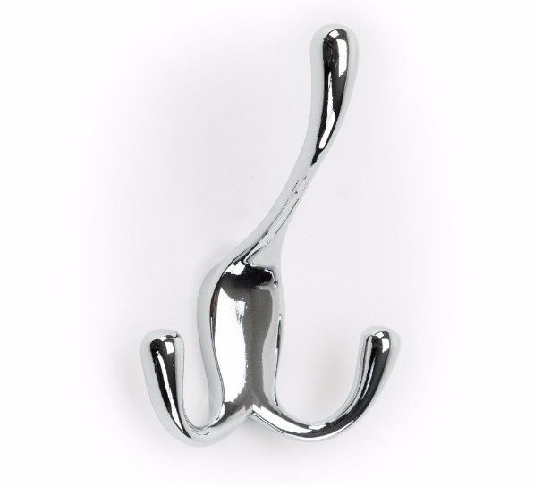 A chrome coat hook is hanging on a white wall.
