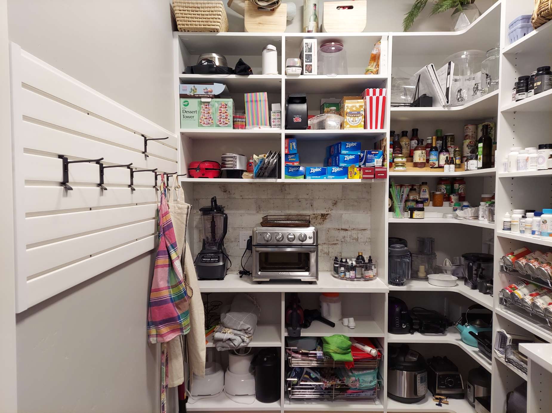 A pantry filled with lots of food and appliances.