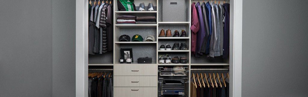 A closet filled with lots of clothes and shoes.