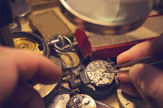 A watch maker repairing a watch.