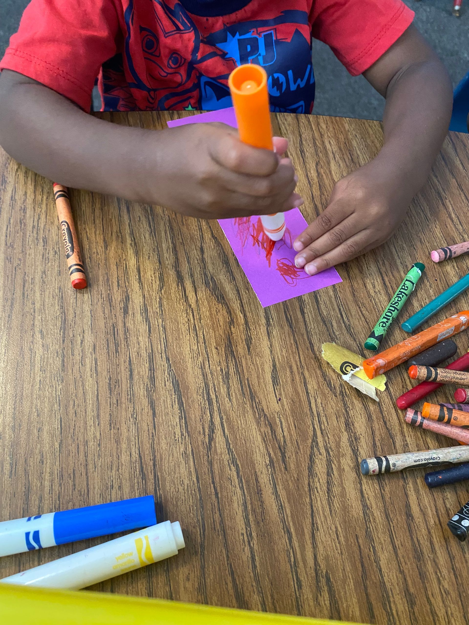 A boy wearing a shirt that says game on it
