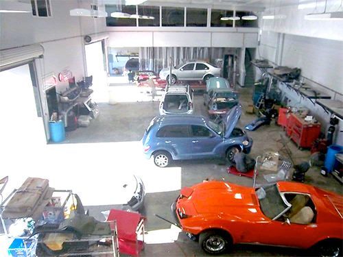 an aerial view of a garage with cars being worked on