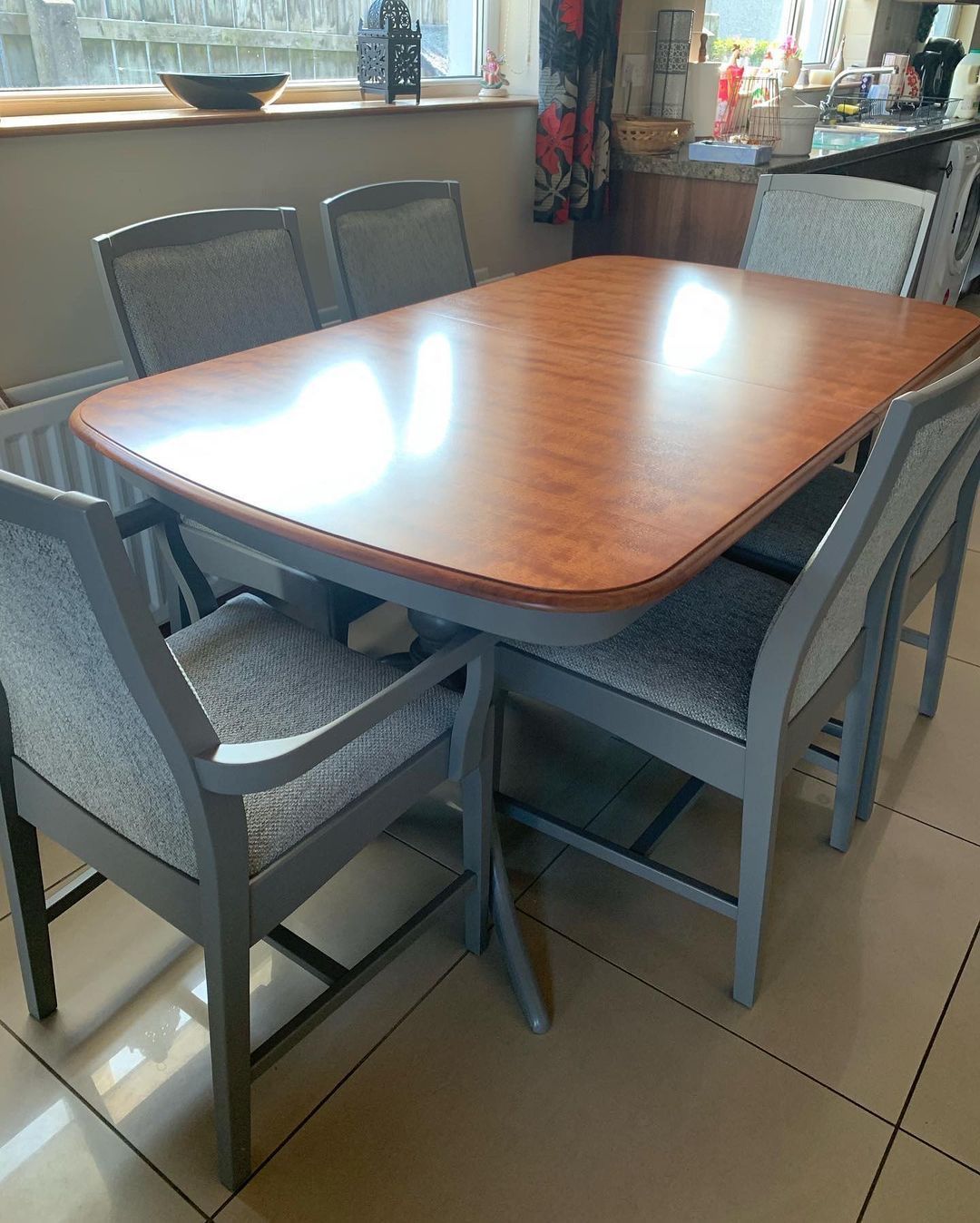 a wooden dining table and chairs in a kitchen