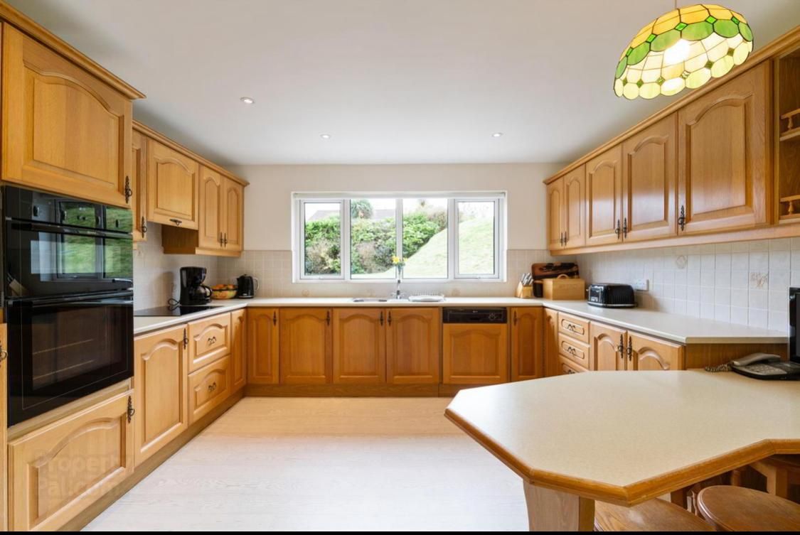 a large kitchen with wooden cabinets and a table