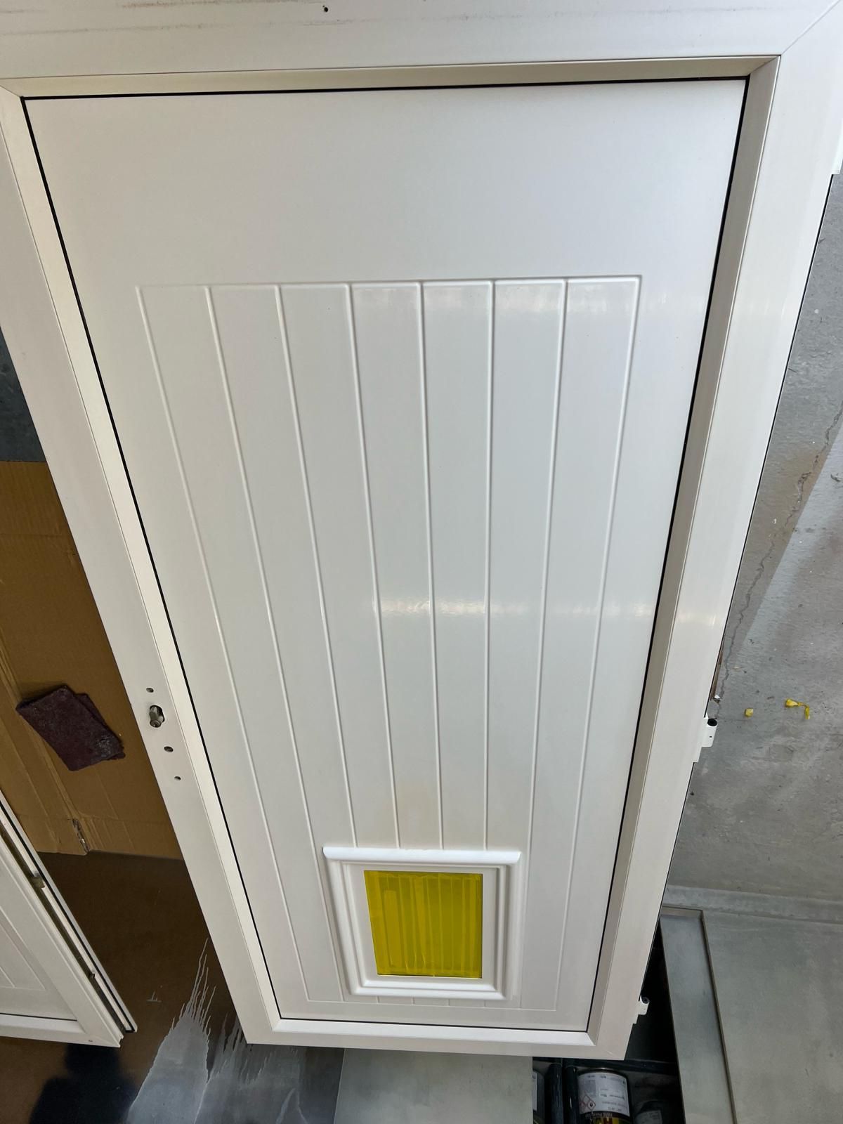 a white door with a yellow window on the top of it .