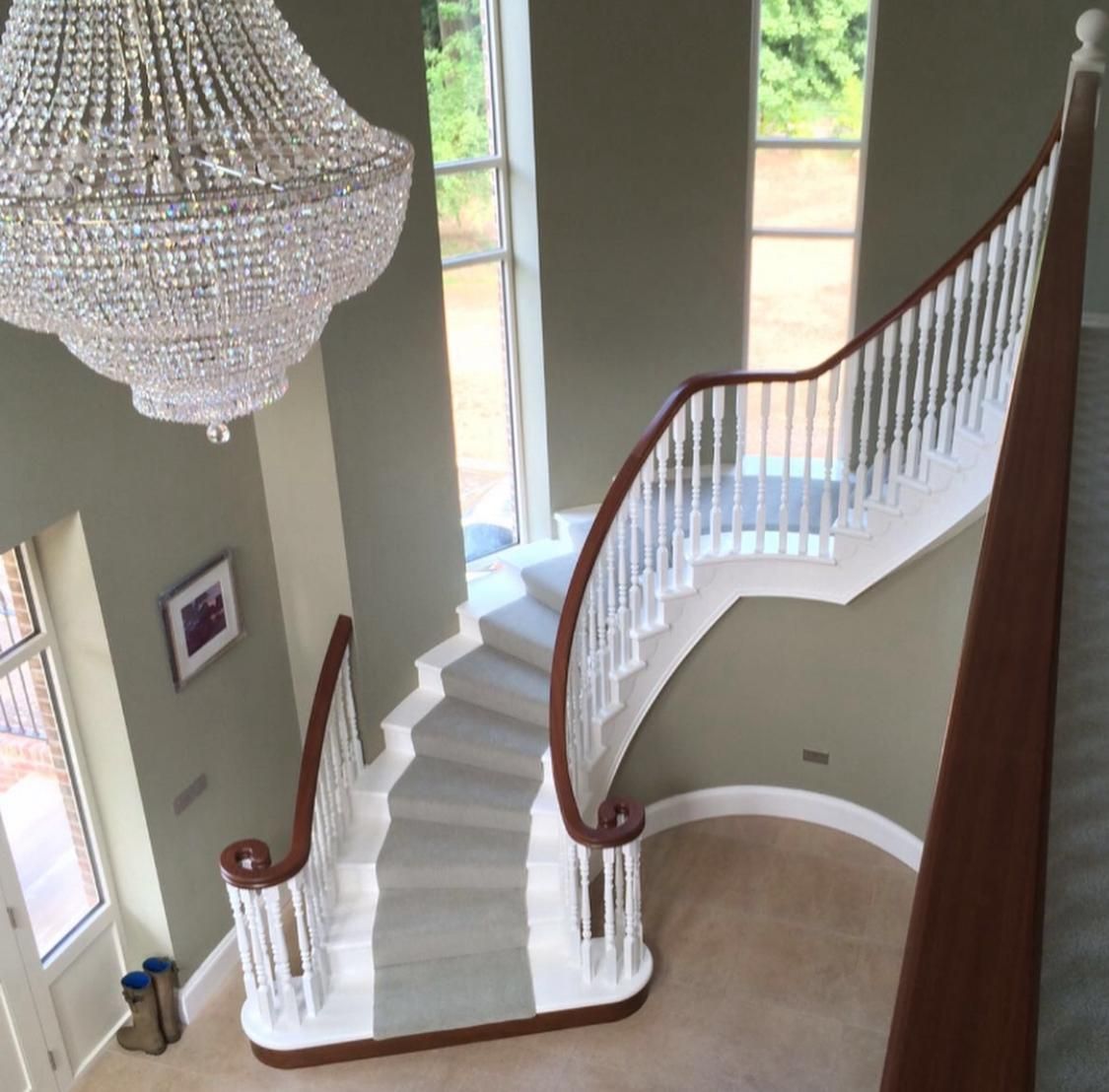 a staircase with a chandelier hanging from the ceiling