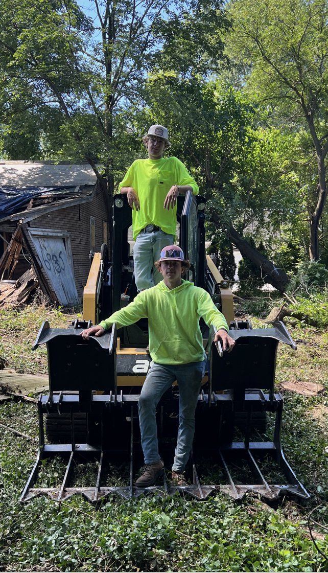 Worker Standing on a Cut Tree