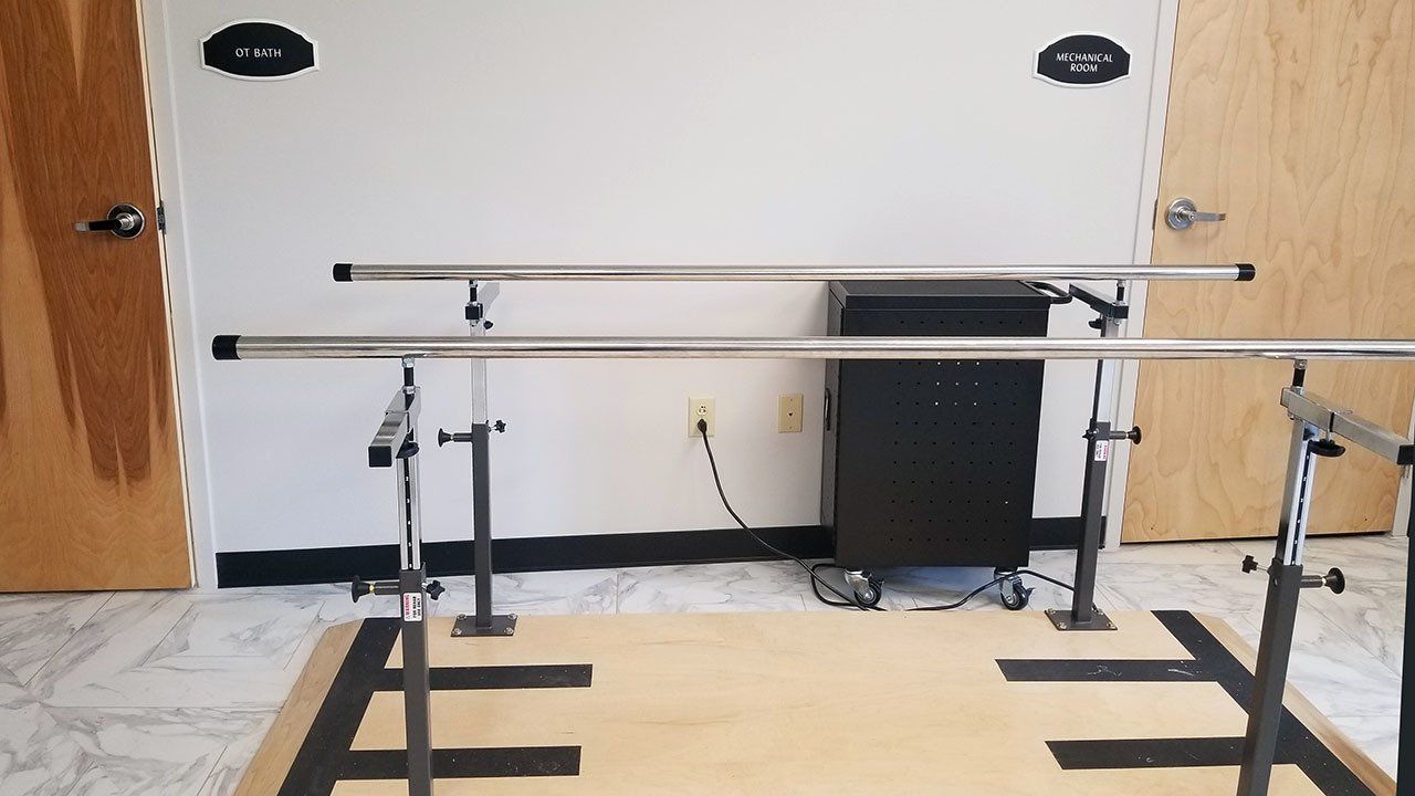 A room with a wooden floor and metal bars on the floor