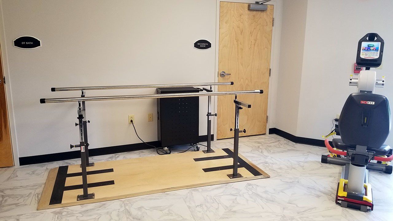 A room with a bicycle , bars , and a door.