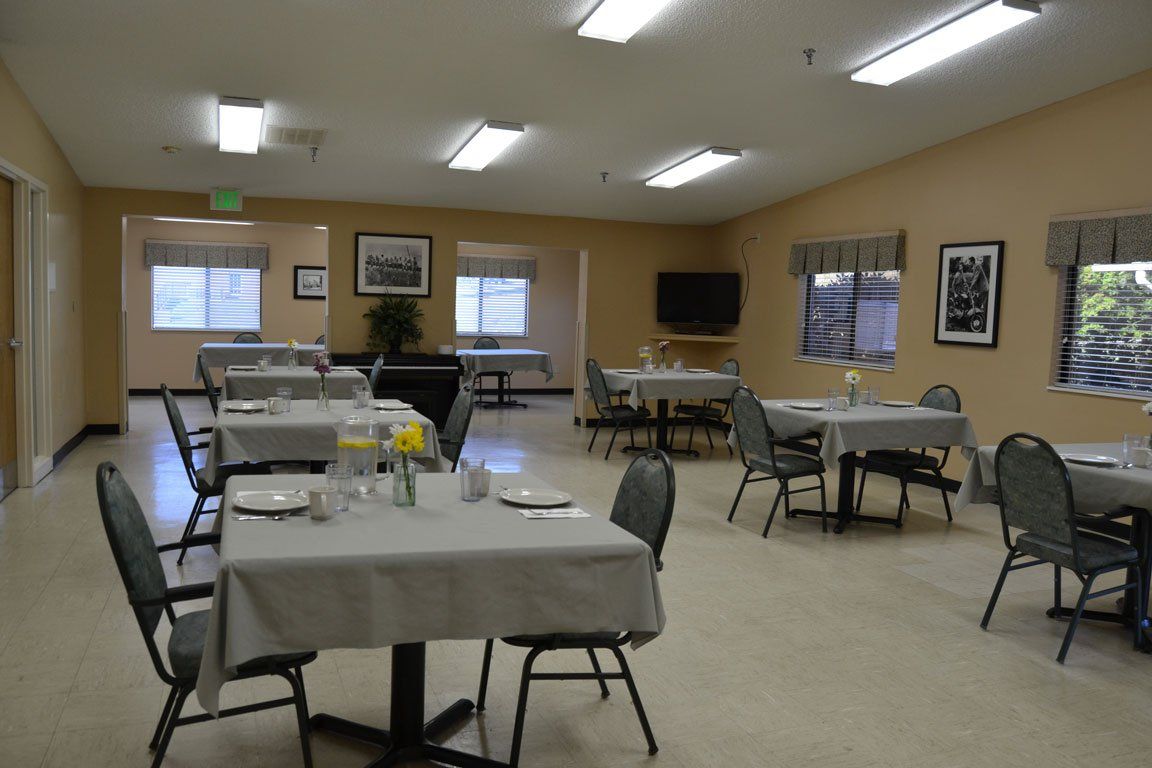 A large room with tables and chairs in it