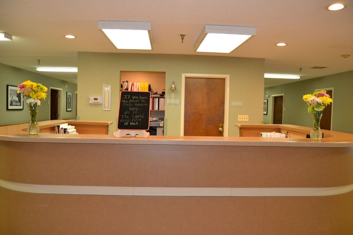 A reception desk in a hospital with flowers on it