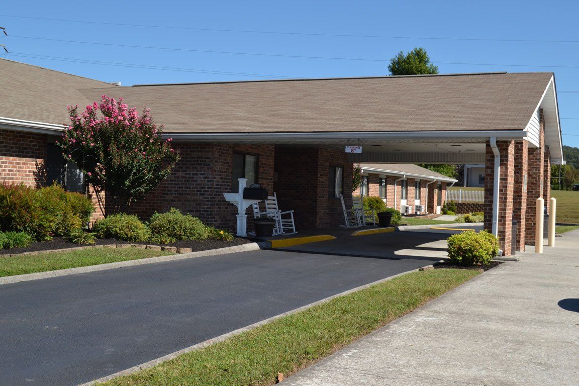 A brick building with a driveway leading to it