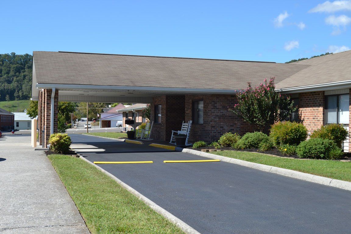 A brick building with a driveway leading to it