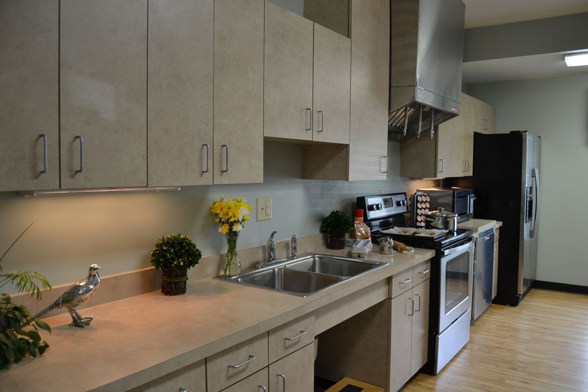 A kitchen with a sink stove and refrigerator