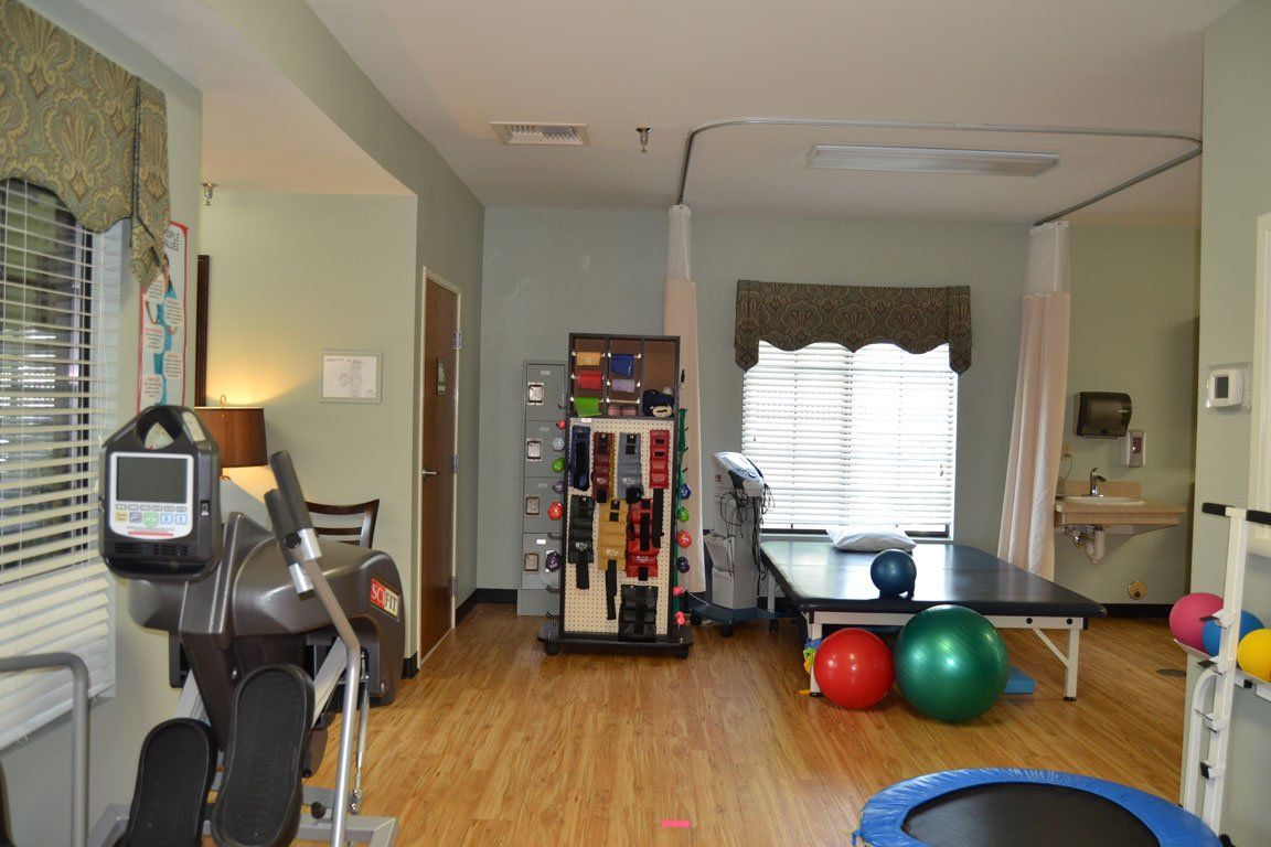 A room with a trampoline and exercise equipment in it