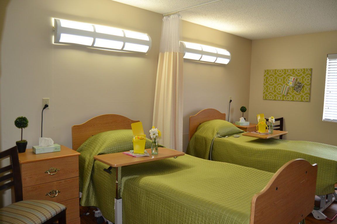 A hospital room with two beds and a table.