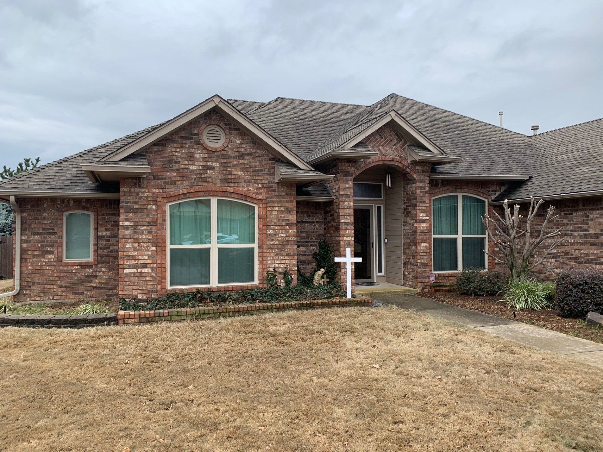 front of large brick ranch home