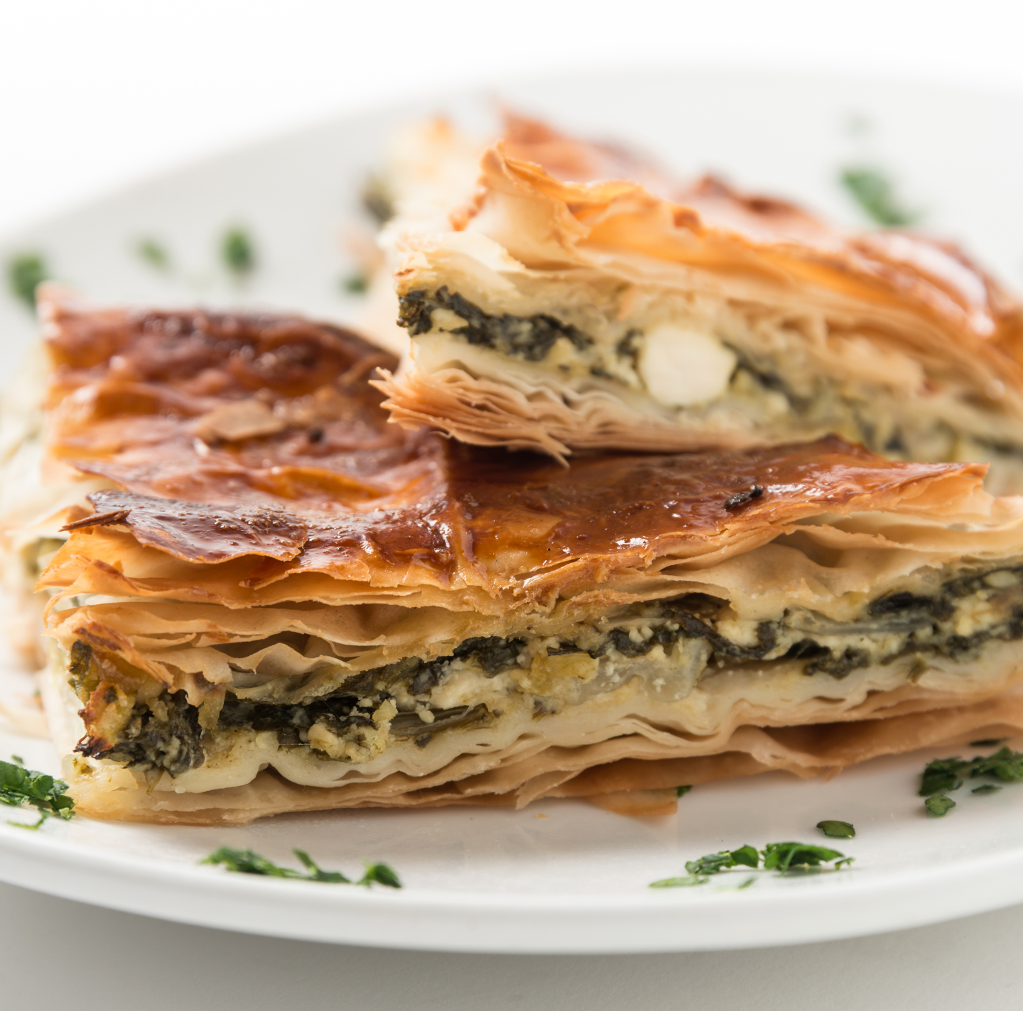 A close up of a plate of food with a piece taken out of it.