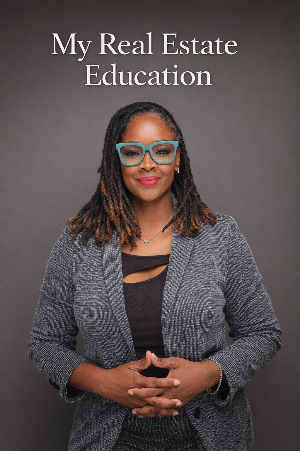 A Black woman smiles in a classroom, wearing a suit, with students in the background.