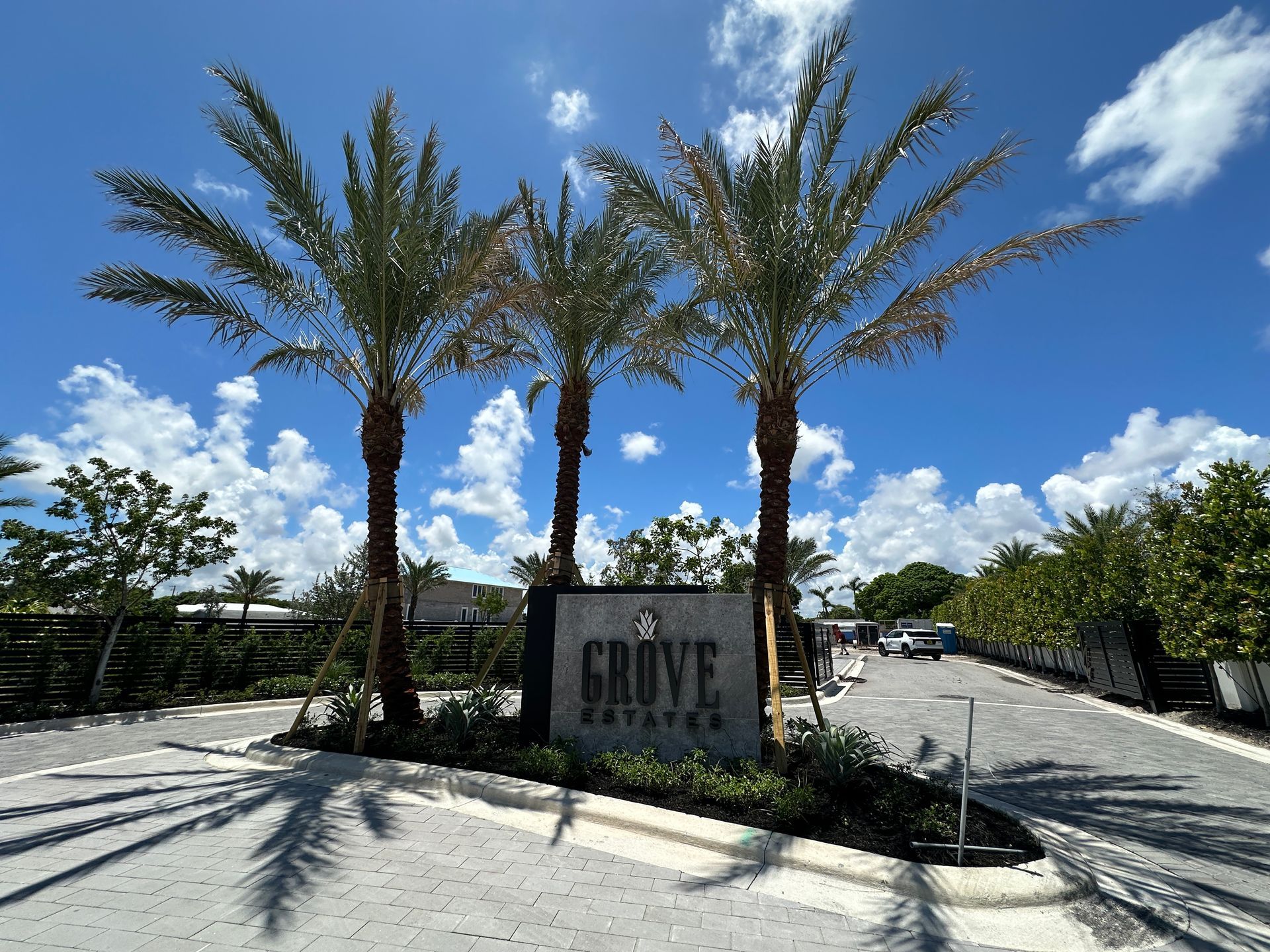 Entrance sign with palm trees; 