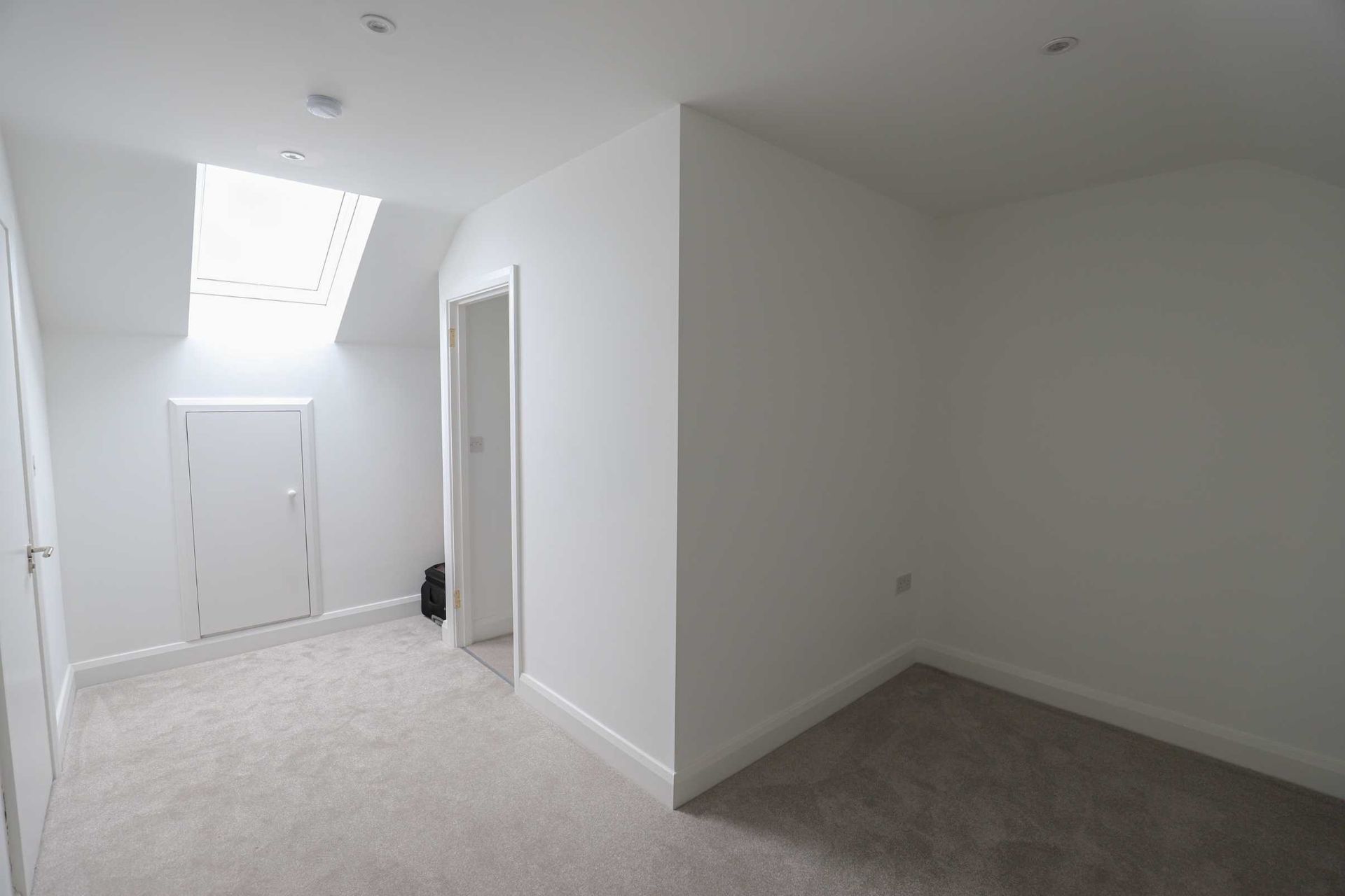 There is a skylight in the ceiling of the room.