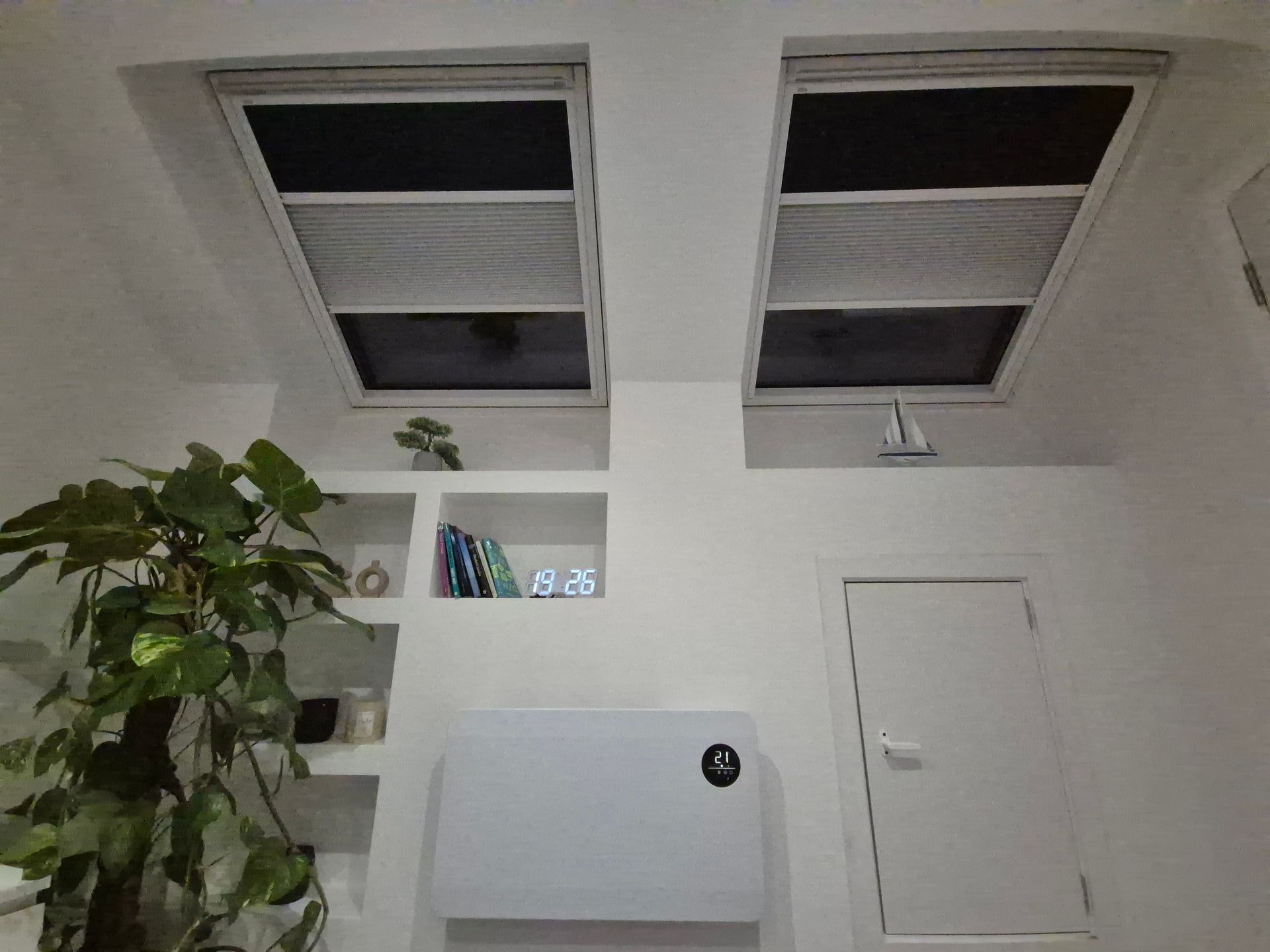 There are two skylights in the ceiling of a room.