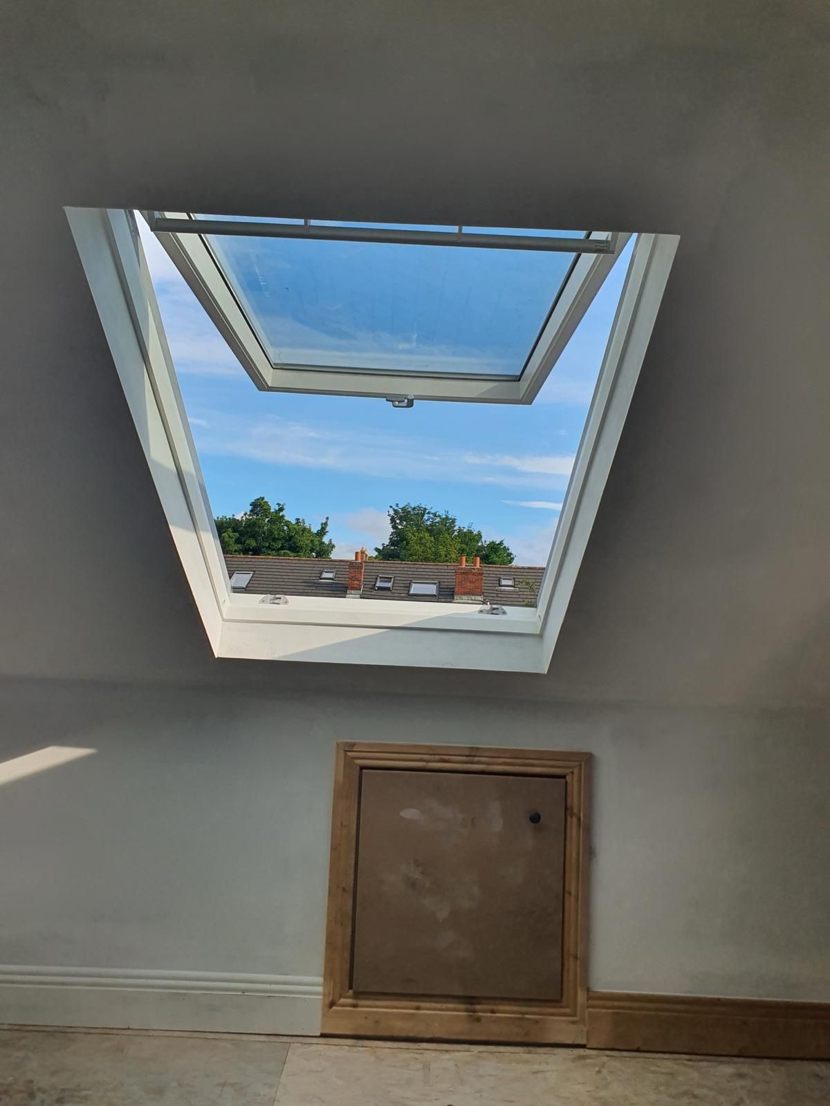 There is a skylight in the ceiling of a room.