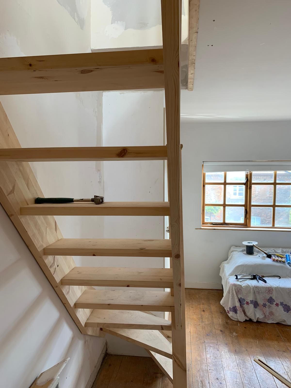 A wooden staircase leading up to the second floor of a house.