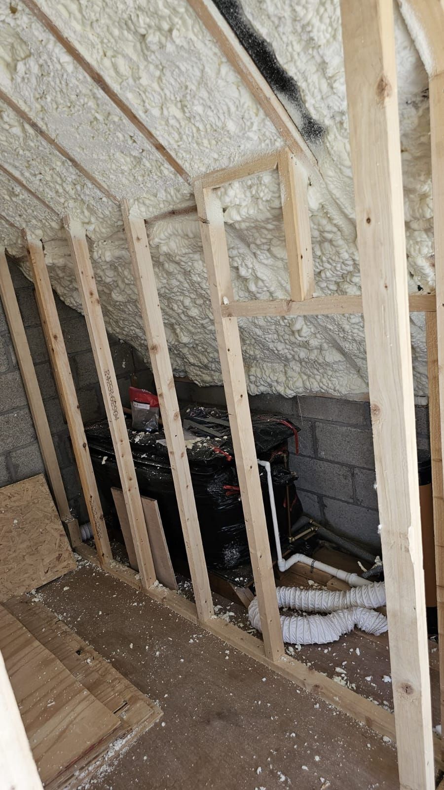 A room with wooden beams and foam on the ceiling.
