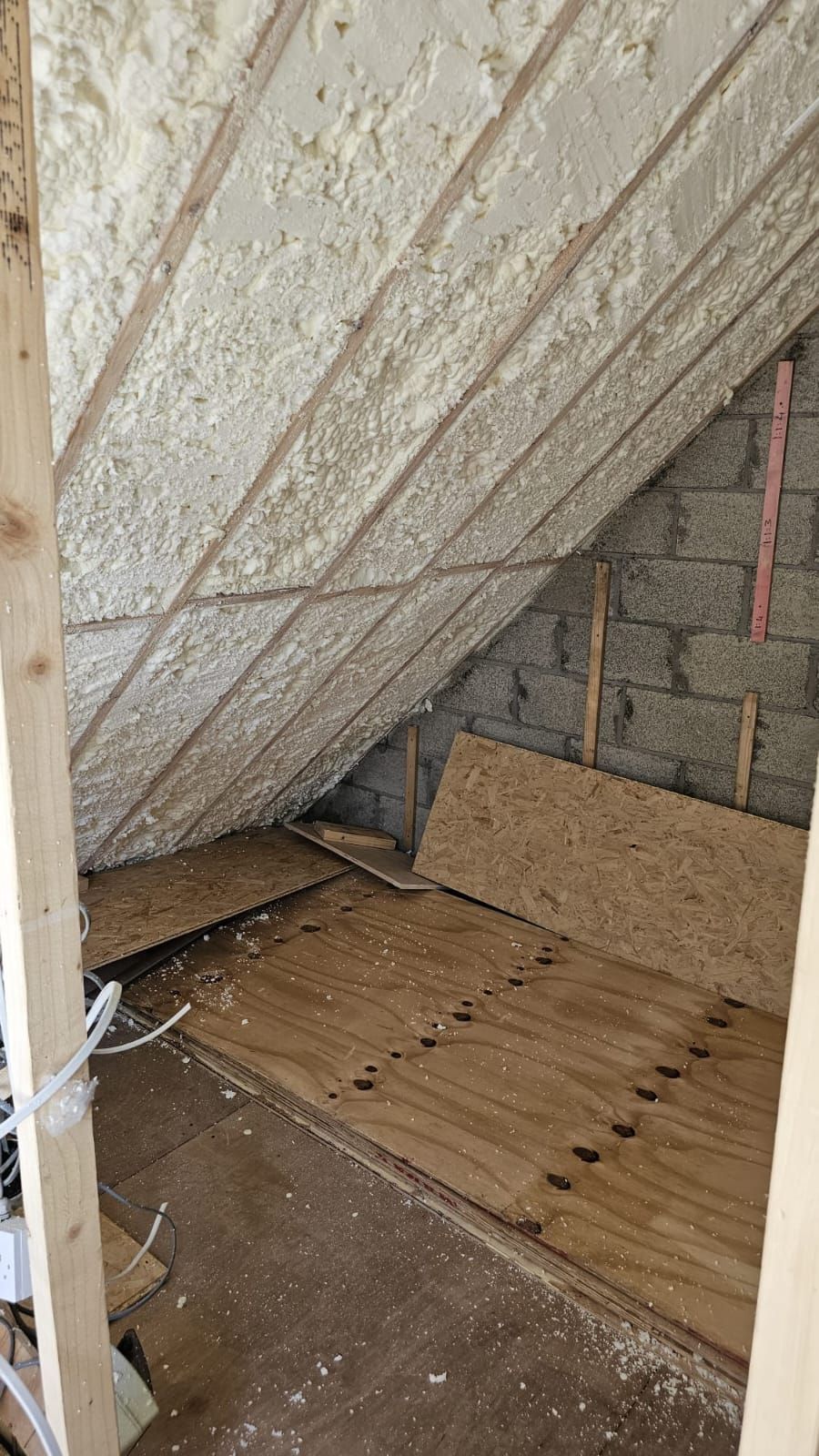 A room with a wooden floor and foam on the ceiling.