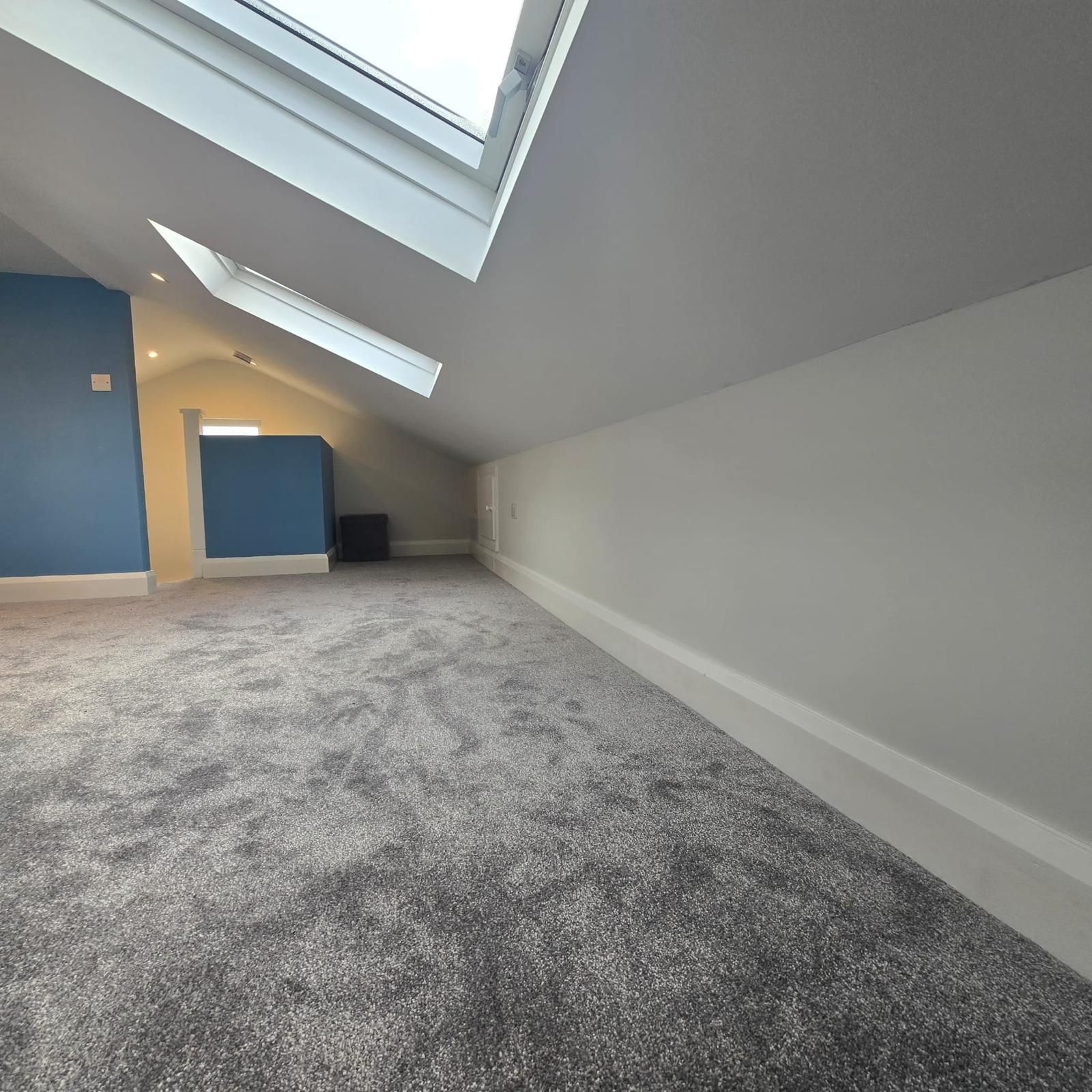 There is a skylight in the ceiling of the room.