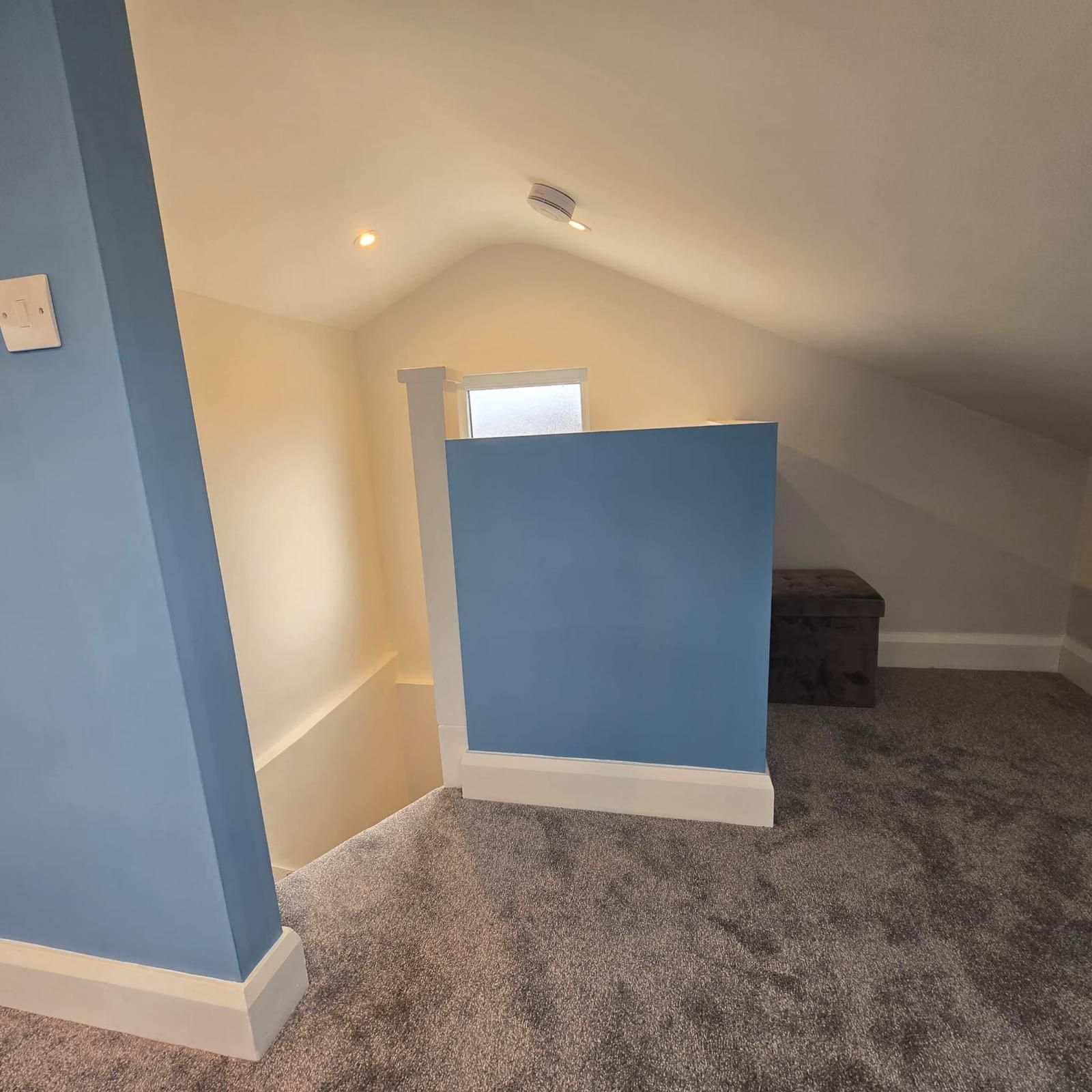 A room with blue walls and a carpeted floor