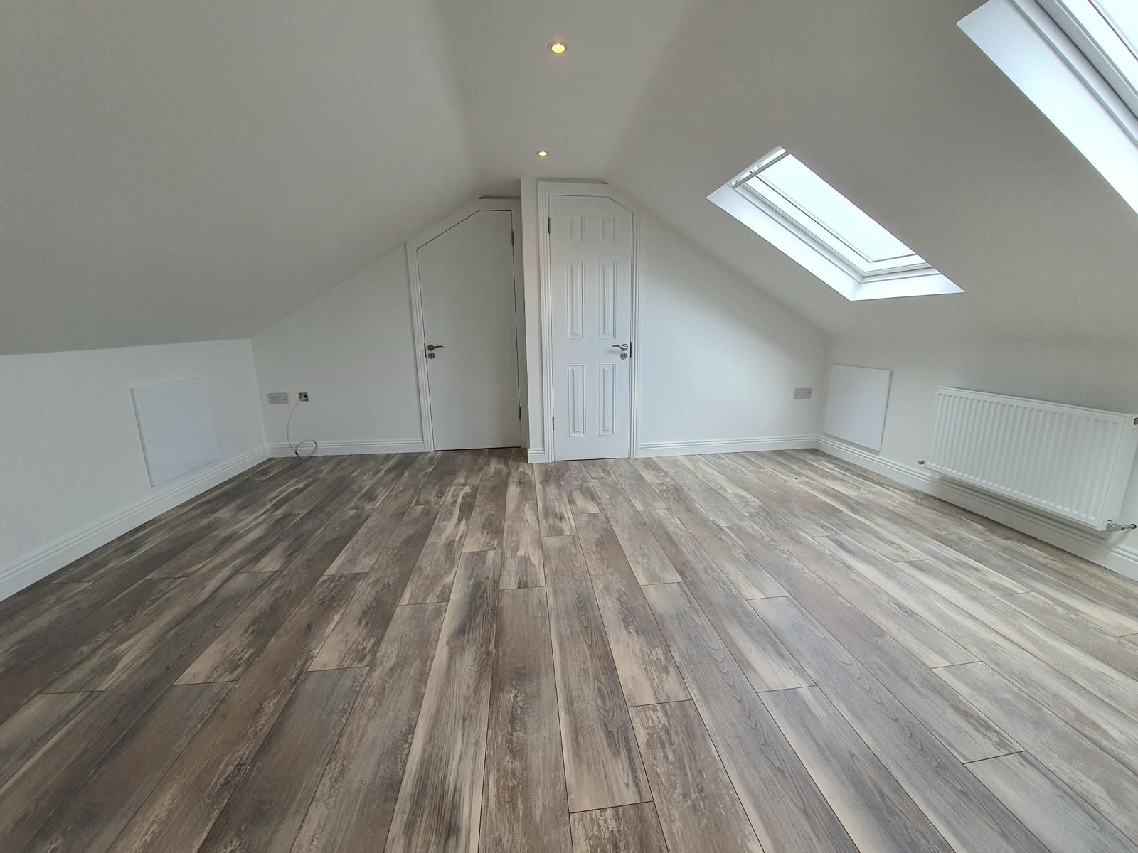 There is a skylight in the ceiling of the room.