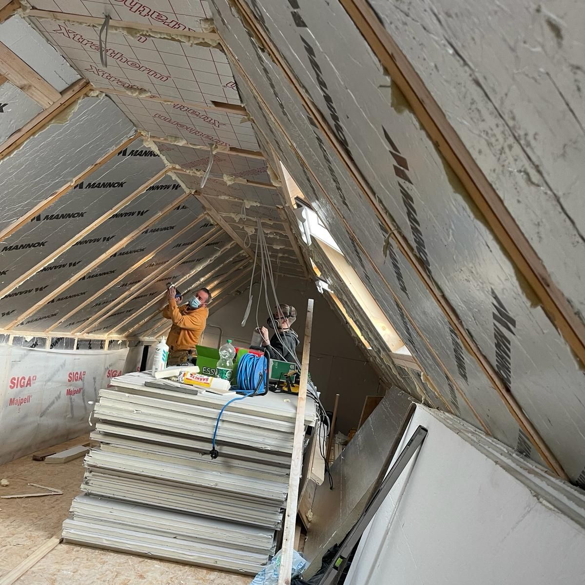 A man is working on the roof of a building.