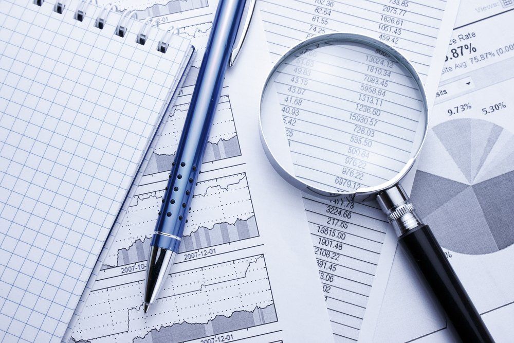 Business Financial Data & Magnifying Glass — Accountants & Bookkeepers in Southern Highlands