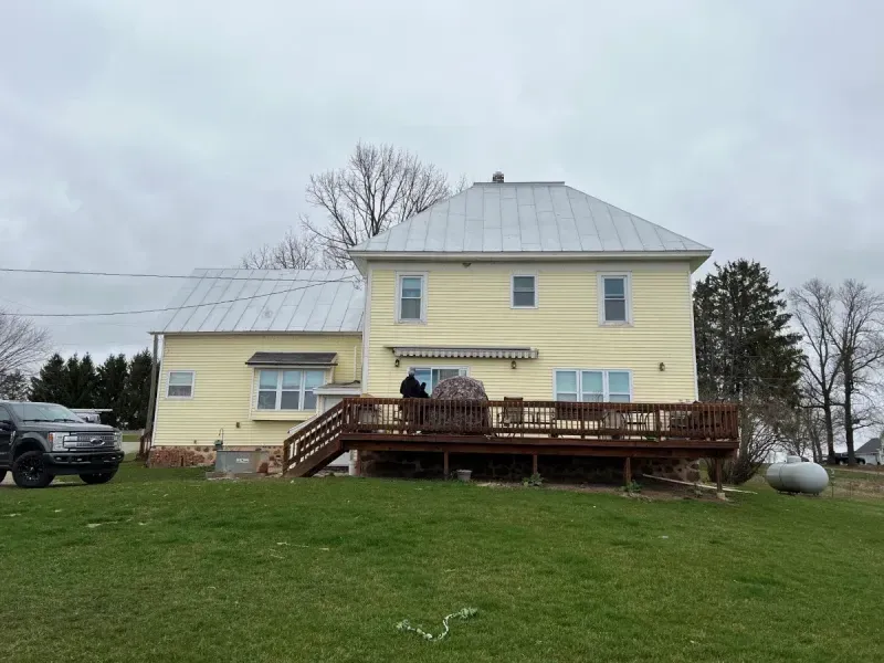 Residential Hail Damage Metal roof and siding replacement by roofing contractor Badgerland Restoration & Remodeling