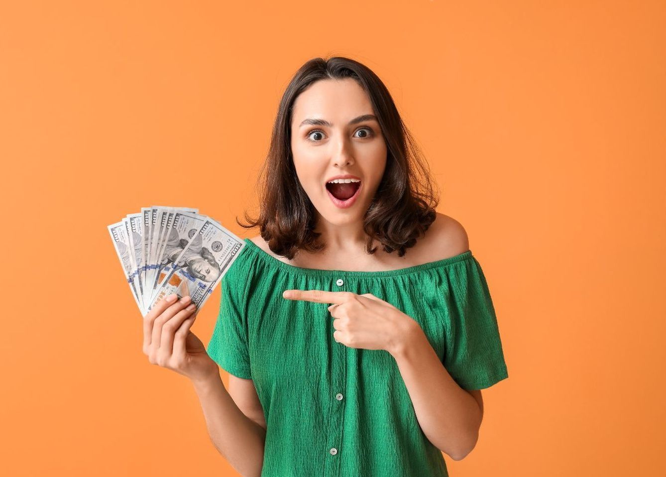 Woman holding money left over from home insurance claim