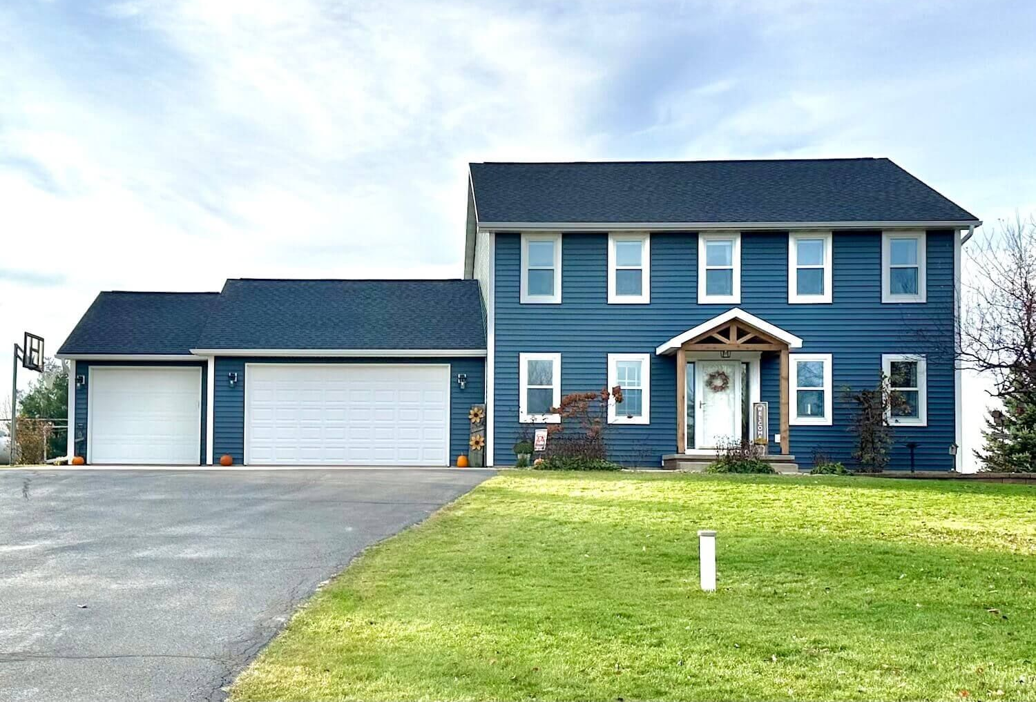 Blue Norandex siding replacement and window shutter removal before and after